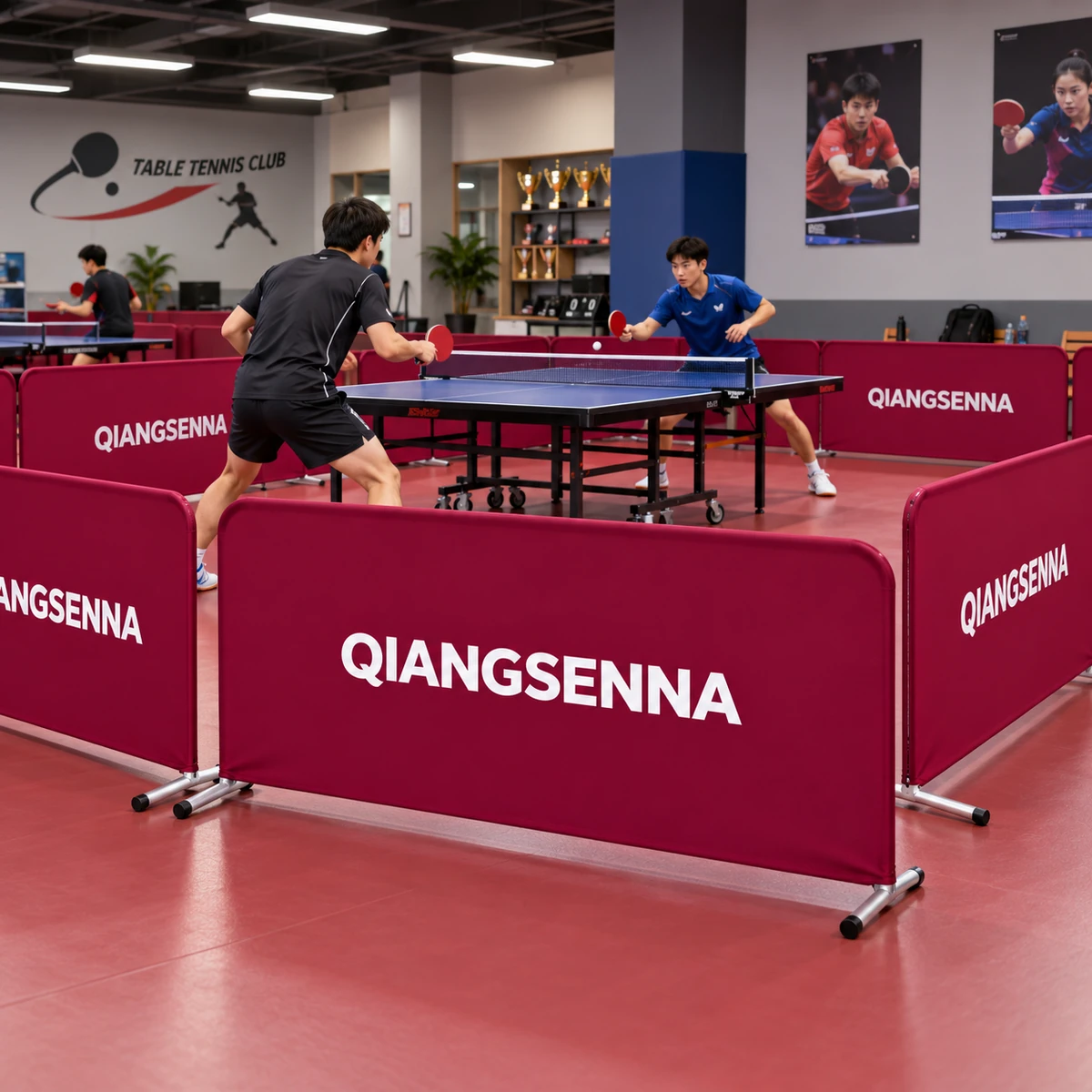 Burgundy QIANGSENNA court barriers around an indoor table tennis area