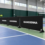 Black modular PVC barriers beside an indoor pickleball court